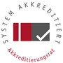 System accreditation seal featuring a red and gray rectangle with a checkmark. Surrounded by the text 'SYSTEM ACCREDITED' and 'Accreditation Council'.